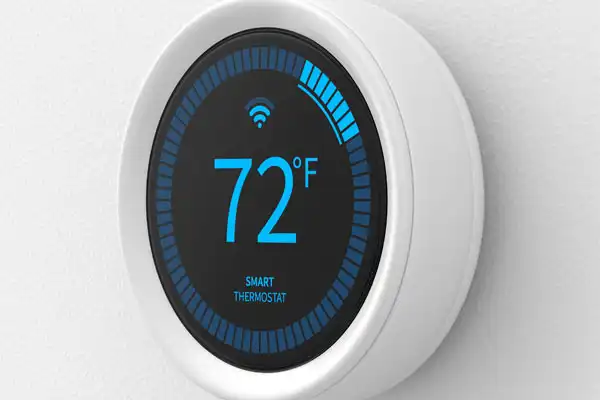 A smart thermostat displaying 72°F with a blue circular progress indicator and a Wi-Fi symbol on a black screen.