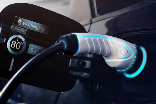 Electric vehicle charging, with a white charging plug connected and a display showing 80% charge and 5 minutes remaining.